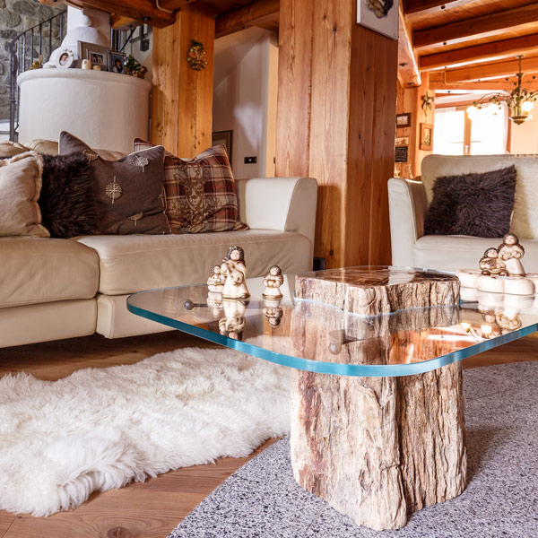 Glass topped table, stone trunk base